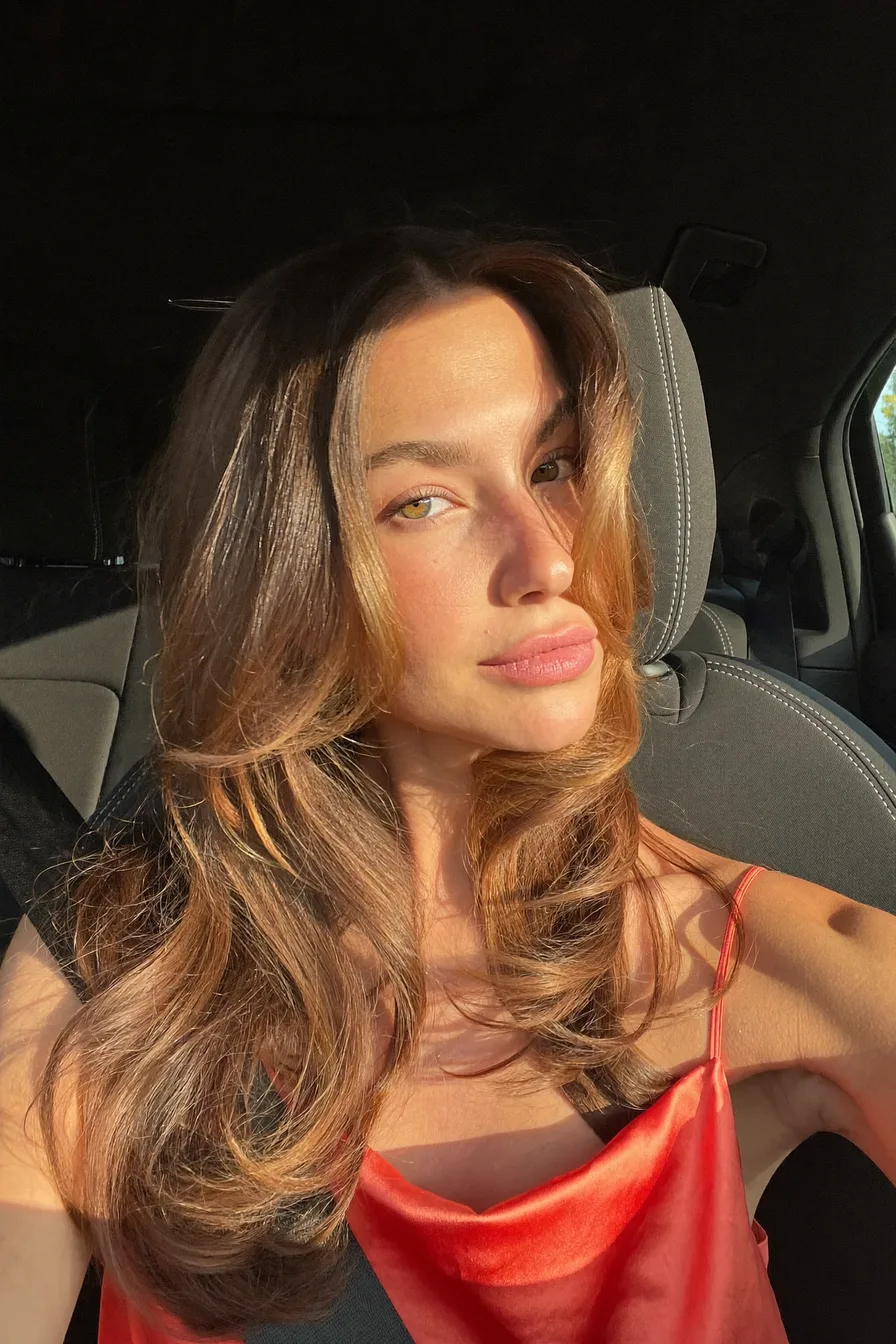 Sun-Kissed Curtain Bangs with Soft, Long Layered Volume