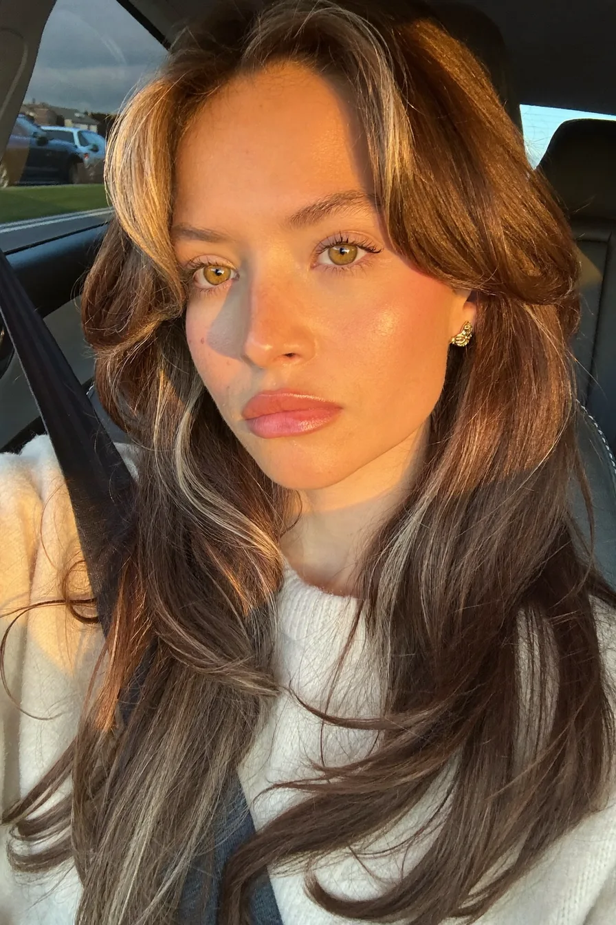 Sun-Kissed Long Layered Hair with Voluminous Curtain Bangs Style