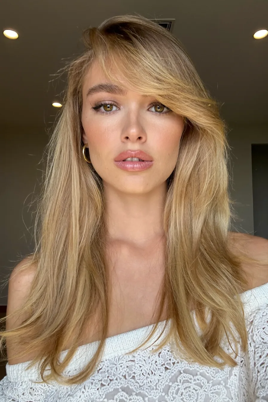 Soft Long Layered Cut with Voluminous Side-Swept Bangs for Added Movement