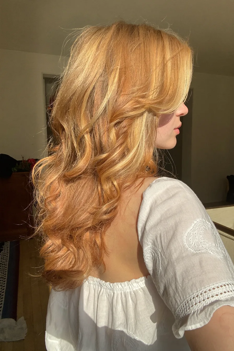 Romantic Long Layered Haircut with Side-Swept Bangs and Soft Waves