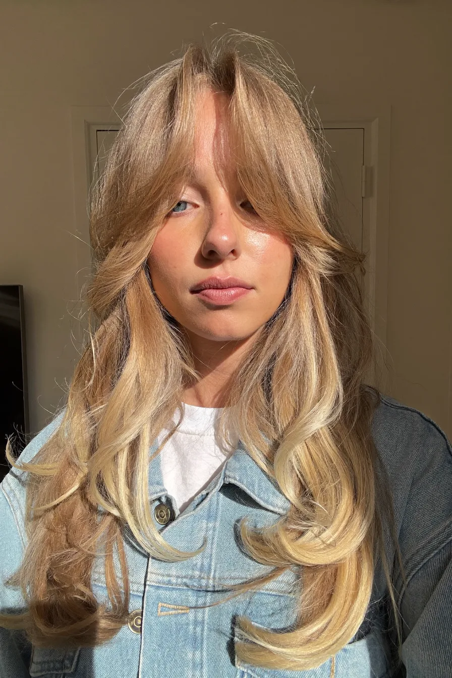 Soft Curtain Bangs with Bouncy Shoulder-Length Layered Cut